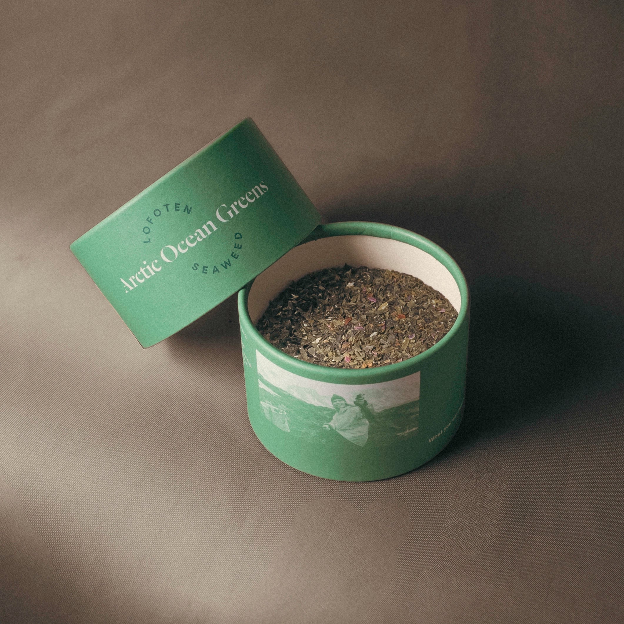 An open Arctic Ocean Greens container on a gray background
